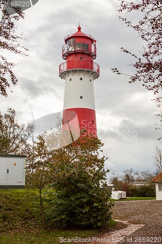 Image of landscape baltic sea dunes lighthouse in red and white 