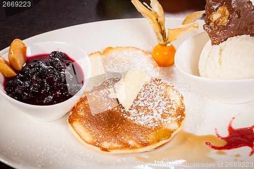 Image of tasty sweet pancakes with vanilla icecream and topping