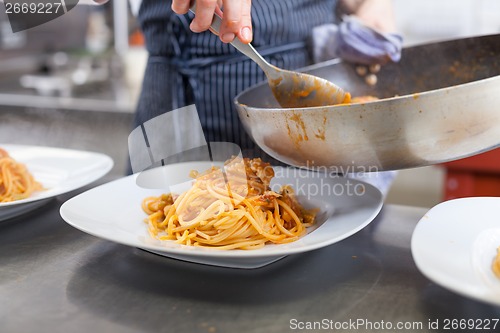 Image of Chef plating up seafood pasta