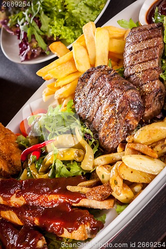 Image of Platter of mixed meats, salad and French fries