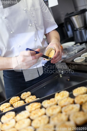 Image of Chef preparing desserts removing them from moulds