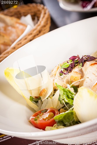 Image of tasty fresh caesar salad with grilled chicken and parmesan 