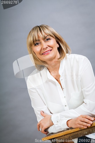 Image of Smiling confident middle-aged blond woman