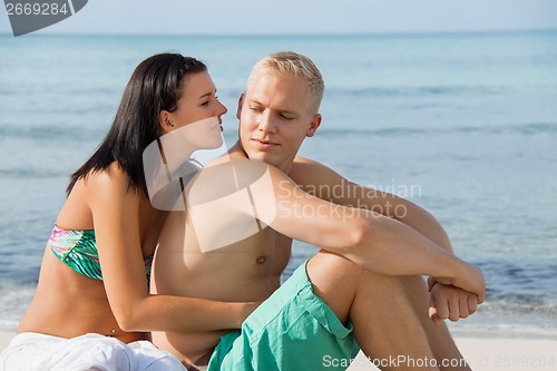 Image of Happy young couple sunbathing