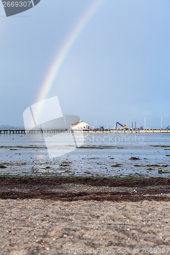 Image of Rainbow over tidal mud flats at the coast