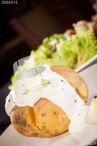 Image of Baked jacket potato with sour cream sauce