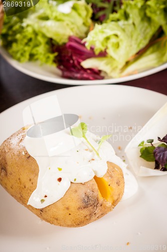 Image of Baked jacket potato with sour cream sauce