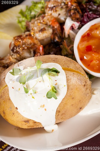 Image of Grilled prawns with endive salad and jacket potato