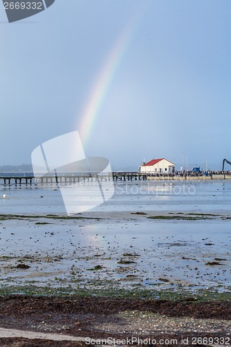 Image of Rainbow over tidal mud flats at the coast