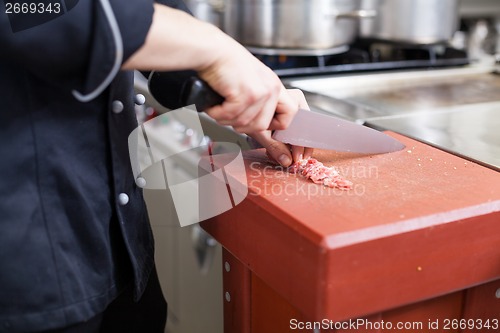 Image of Chef or butcher dicing meat