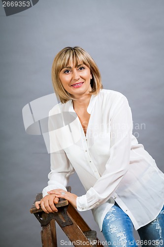 Image of Smiling confident middle-aged blond woman