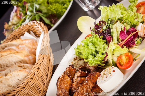 Image of grilled beef stripes fresh salad and goat cheese