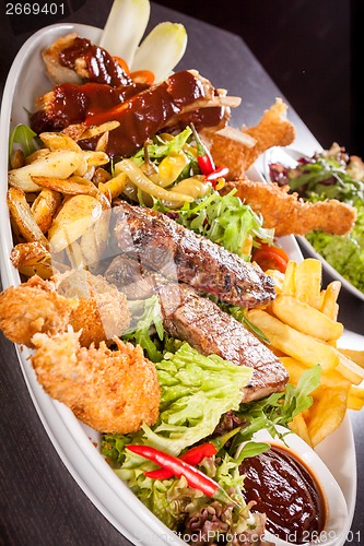 Image of Platter of mixed meats, salad and French fries