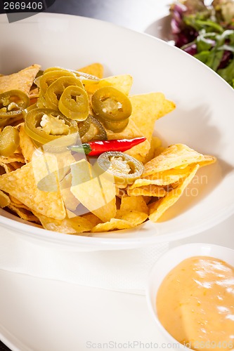 Image of Nachos with cheese sauce and chilli pepperoni