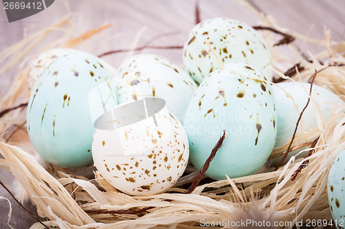 Image of Three natural blue Easter eggs in a basket