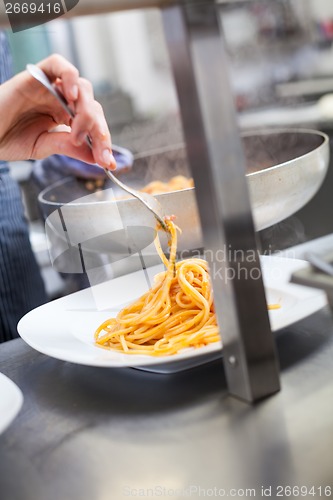 Image of Chef plating up seafood pasta