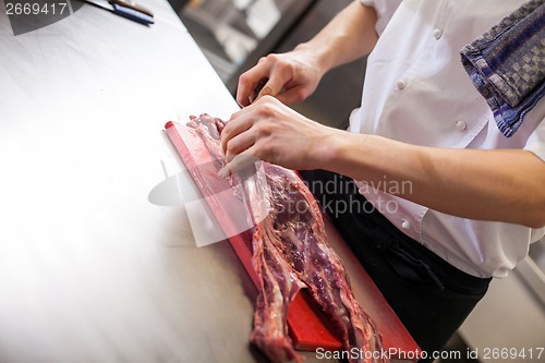 Image of Chef or butcher dicing meat