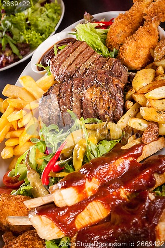 Image of Platter of mixed meats, salad and French fries