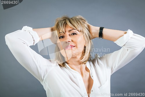 Image of Smiling confident middle-aged blond woman