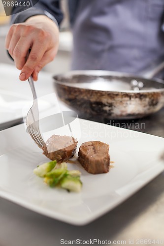 Image of Chef plating up food in a restaurant