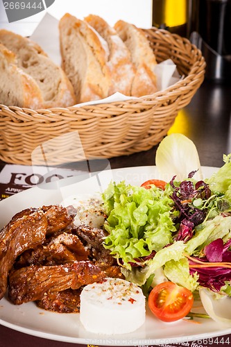 Image of grilled beef stripes fresh salad and goat cheese