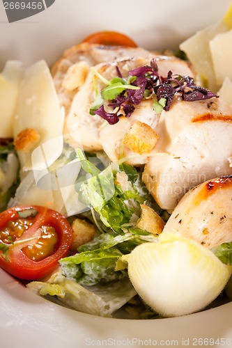 Image of tasty fresh caesar salad with grilled chicken and parmesan 