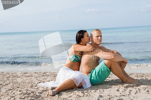 Image of Happy young couple sunbathing