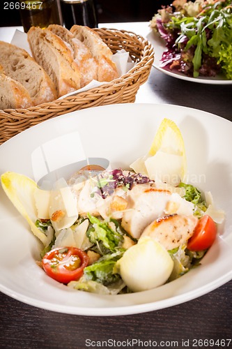 Image of tasty fresh caesar salad with grilled chicken and parmesan 