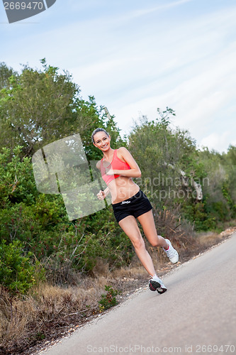 Image of young athletic woman runner jogger outdoor