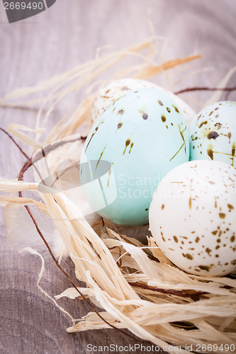 Image of Three natural blue Easter eggs in a basket