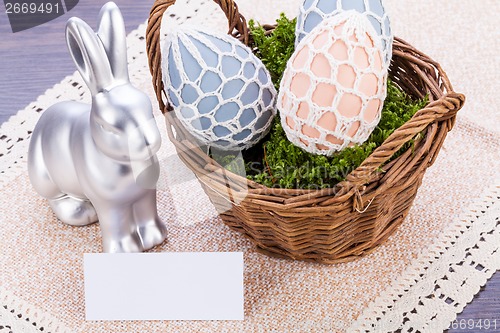 Image of Easter still life with a silver bunny and eggs