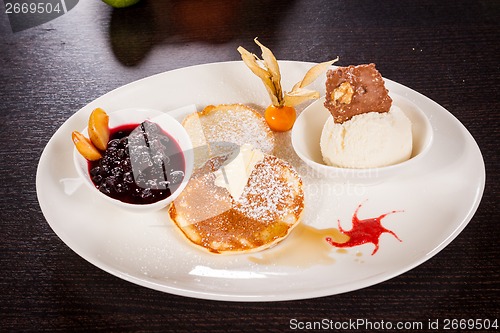 Image of tasty sweet pancakes with vanilla icecream and topping