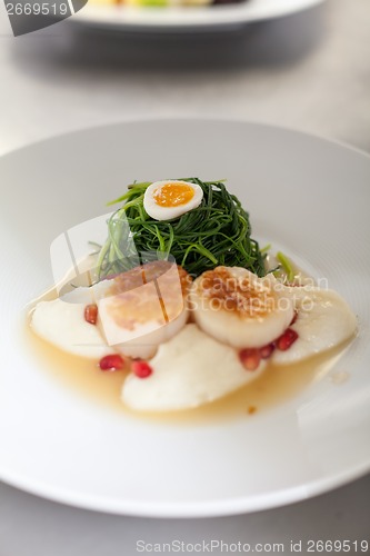 Image of Delicious starter of stuffed savoury eggs and scallops