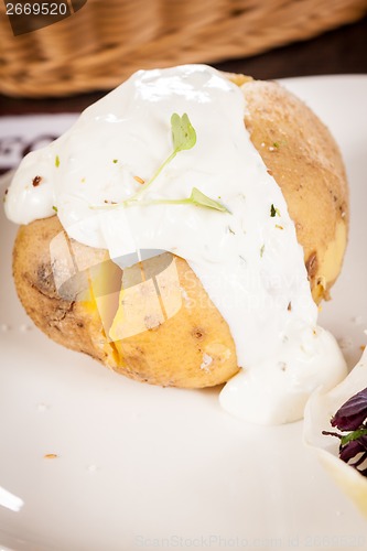 Image of Baked jacket potato with sour cream sauce