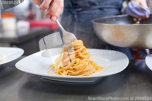 Image of Chef plating up seafood pasta