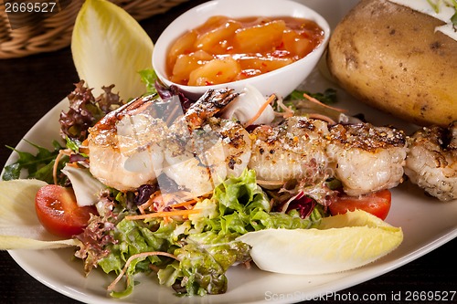 Image of Grilled prawns with endive salad and jacket potato