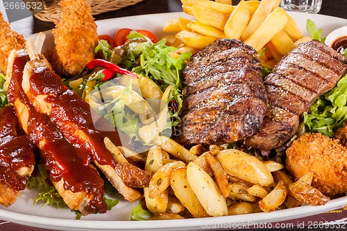 Image of Platter of mixed meats, salad and French fries