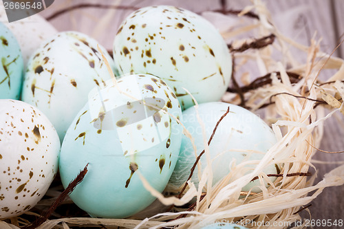 Image of Three natural blue Easter eggs in a basket