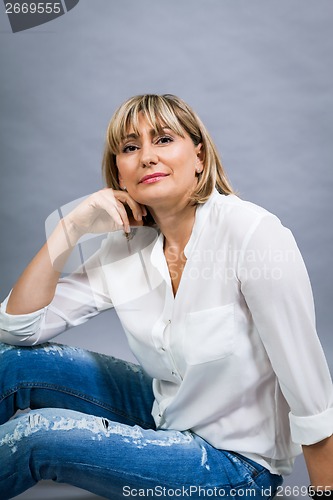 Image of Smiling confident middle-aged blond woman