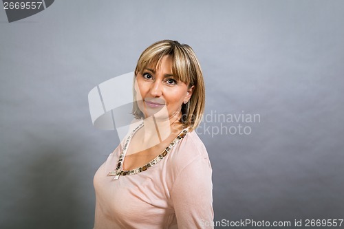 Image of Smiling confident middle-aged blond woman