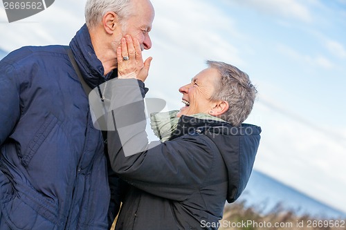 Image of Elderly couple embracing and celebrating the sun