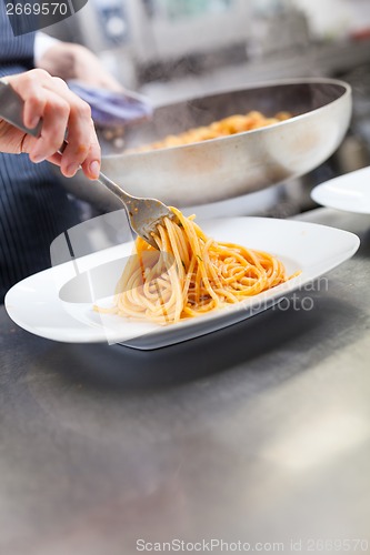Image of Chef plating up seafood pasta