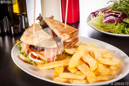 Image of Club sandwich with potato French fries