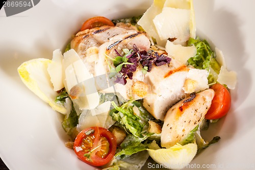 Image of tasty fresh caesar salad with grilled chicken and parmesan 