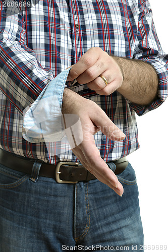 Image of Man rolls up sleeves