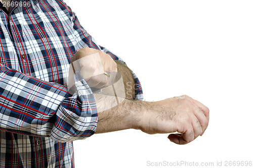 Image of Man rolls up sleeves