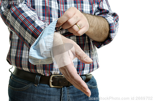 Image of Man rolls up sleeves