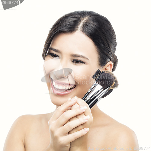 Image of Asian woman with make-up brushes