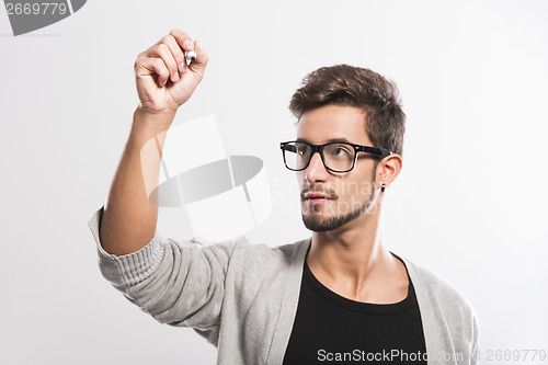 Image of Young man writing on a glass