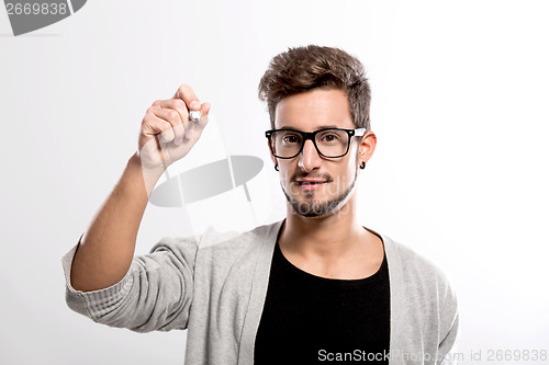 Image of Young man writing on a glass